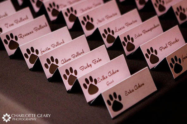 Pink and brown escort cards at the wedding of two log lovers