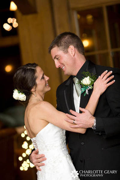 Groom in green and white striped tie and boutonniere