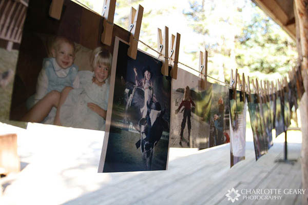 Photos of the bride and groom through the years, displayed on a clothesline with clothespins