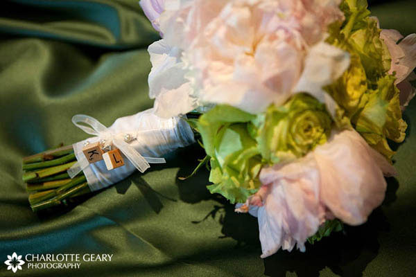 Scrabble tiles with the initials of the bride and groom, fastened to the base of the bridal bouquet
