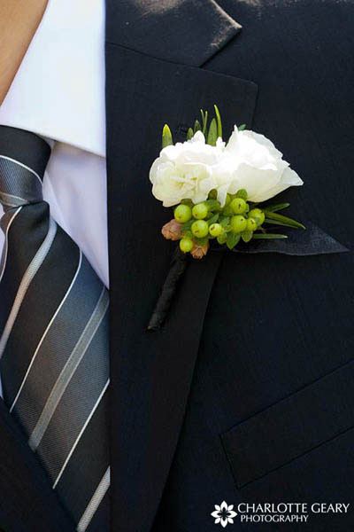 Groom in striped tie and green and white boutonniere