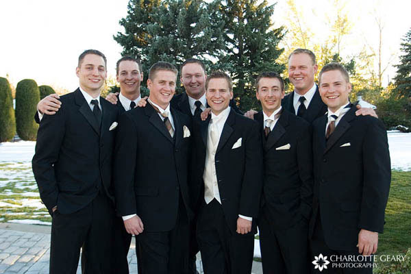 Groomsmen in black suits with brown and black ties