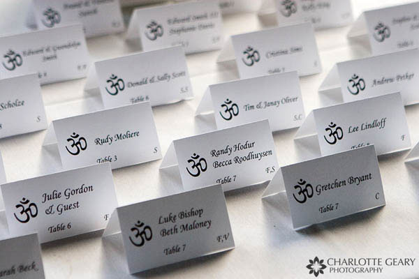 Wedding place cards with the "om" symbol at the wedding of two yoga instructurs