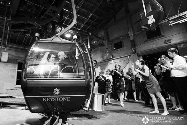 Bride and groom departing by ski gondola