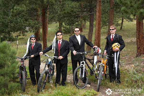 Groom and groomsmen with mountain bikes and decorated bike helmets