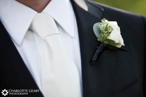 White boutonniere and tie