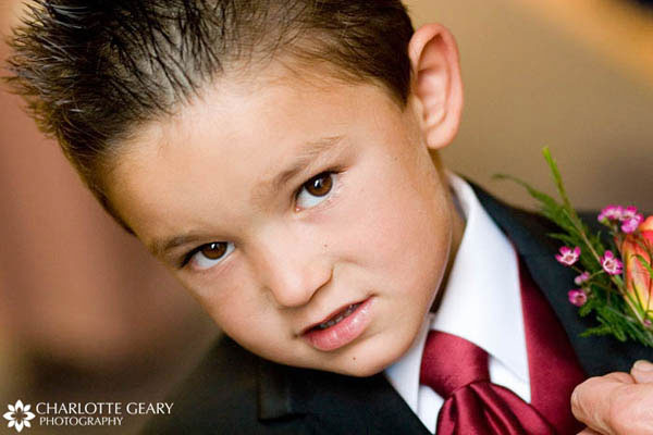 Ring bearer with spiked hair and red tie