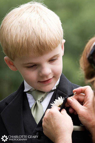 Ring bearer with light green tie and daisy boutonniere